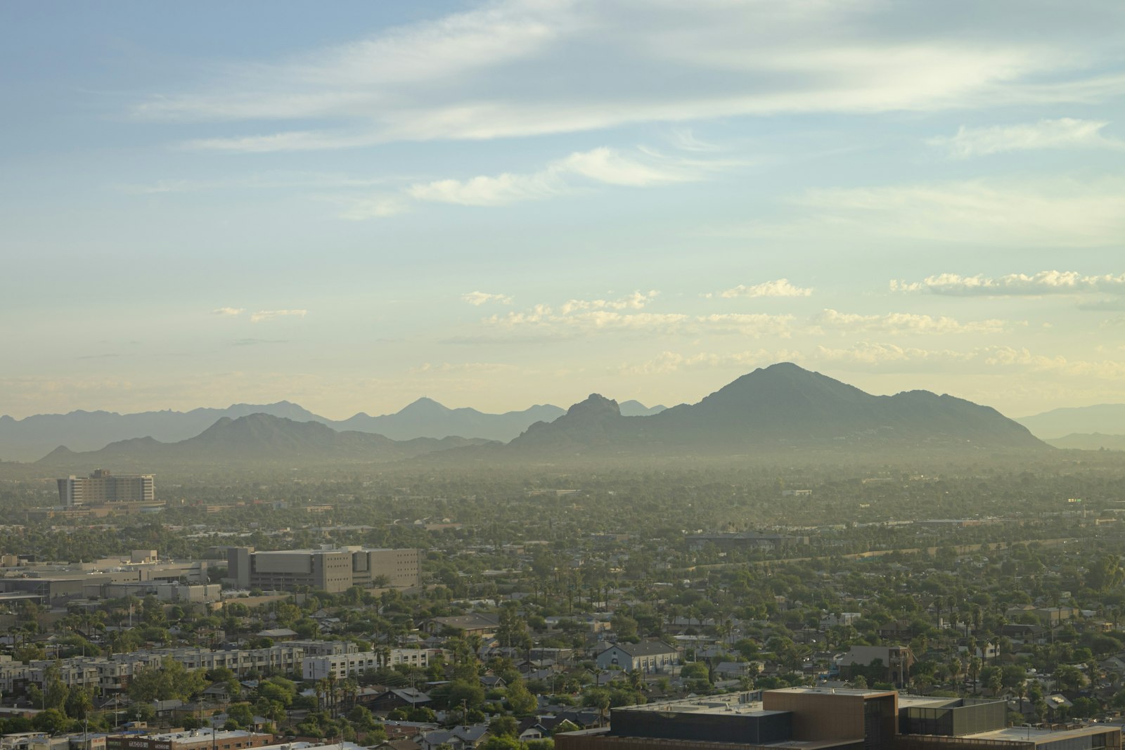 Downtown Phoenix skyline at sunrise with Camelback Mountain in the distance