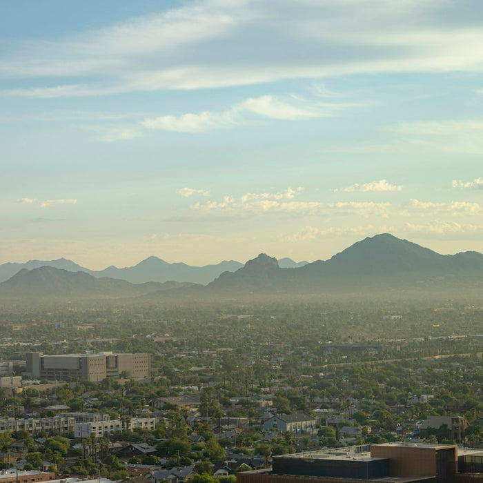Downtown Phoenix skyline at sunrise with Camelback Mountain in the distance