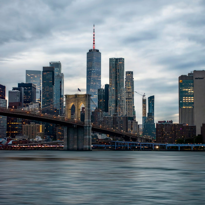 New York City skyline with the Brooklyn Bridge at dusk