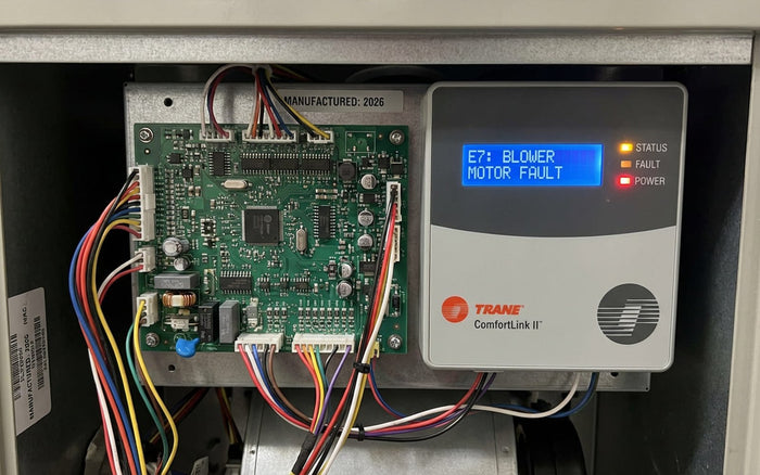 Trane furnace control board displaying a blower motor fault code